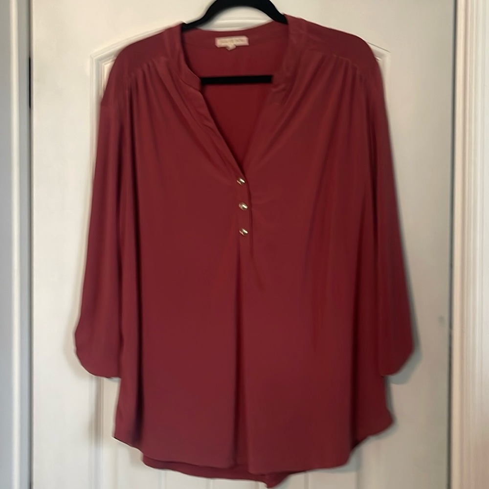 Rust colored, V-neck blouse.
